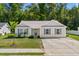 Beige house with teal shutters, driveway, and grassy yard at 3348 Merganser Dr., Conway, SC 29527
