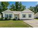 House exterior with teal shutters, landscaping, and a driveway at 3348 Merganser Dr., Conway, SC 29527