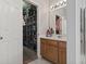 Bathroom with wood vanity, large mirror, and walk-in closet at 394 Blackberry Ln., Myrtle Beach, SC 29579