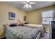 Small bedroom with twin beds, a ceiling fan, and ocean-themed decor at 400 N Waccamaw Dr. # 304, Garden City Beach, SC 29576