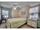 Bedroom with a queen bed and ocean view, featuring a ceiling fan and dresser at 400 N Waccamaw Dr. # 304, Garden City Beach, SC 29576