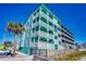 Three-story teal building, multiple balconies, beach access at 400 N Waccamaw Dr. # 304, Garden City Beach, SC 29576