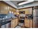 Well-equipped kitchen with light wood cabinets and stainless steel appliances at 400 N Waccamaw Dr. # 304, Garden City Beach, SC 29576
