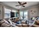 Living room with ocean view, comfy sofas, and a large TV at 400 N Waccamaw Dr. # 304, Garden City Beach, SC 29576