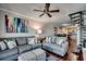Cozy living room featuring gray sofas, a spiral staircase, and large artwork at 400 N Waccamaw Dr. # 304, Garden City Beach, SC 29576