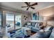 Living room with ocean view, comfy sofas, and a ceiling fan at 400 N Waccamaw Dr. # 304, Garden City Beach, SC 29576
