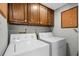 Bright laundry room, featuring washer, dryer, and ample cabinets at 409 77Th Ave. N # B, Myrtle Beach, SC 29572