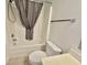 Bathroom features a shower and tub with a shower curtain, toilet, and neutral wall color at 4273 Santolina Way # E, Murrells Inlet, SC 29576