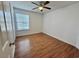 Cozy bedroom with wood-look floors, ceiling fan, and window at 4273 Santolina Way # E, Murrells Inlet, SC 29576