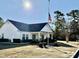 Community clubhouse with manicured landscaping and American flag at 4273 Santolina Way # E, Murrells Inlet, SC 29576
