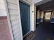 Entrance to a unit with a blue door, unit 'E' signage, welcome mat, and tiled floor hallway at 4273 Santolina Way # E, Murrells Inlet, SC 29576