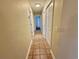 Long hallway featuring tiled flooring, neutral walls, and white doors at 4273 Santolina Way # E, Murrells Inlet, SC 29576