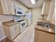 A kitchen with stainless sink, white appliances and cabinetry, and tile flooring at 4273 Santolina Way # E, Murrells Inlet, SC 29576
