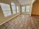Bright living room with large windows, tile flooring, and high ceiling at 4273 Santolina Way # E, Murrells Inlet, SC 29576
