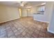 Open living area with tile flooring, ceiling fan, access to other rooms, and neutral walls at 4273 Santolina Way # E, Murrells Inlet, SC 29576