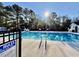 Sparkling community pool surrounded by lush trees and clear skies at 4273 Santolina Way # E, Murrells Inlet, SC 29576