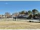 Fenced tennis courts with nearby community buildings and clear skies at 4273 Santolina Way # E, Murrells Inlet, SC 29576