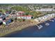 Aerial view of community showcasing waterfront condos, docks, and verdant trees at 4560 Greenbriar Dr. # 102-B, Little River, SC 29566