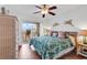 Bedroom with ceiling fan, woven furniture, and access to a scenic balcony with seating at 4560 Greenbriar Dr. # 102-B, Little River, SC 29566