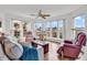 Inviting living room with large windows offering scenic views of the marsh and waterway at 4560 Greenbriar Dr. # 102-B, Little River, SC 29566