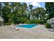 Inviting community pool with lounge chairs and mature trees at 4560 Greenbriar Dr. # 102-B, Little River, SC 29566
