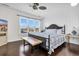 Main bedroom with a king-size bed, dark wood floors, and large windows at 4600 Marion Circle, North Myrtle Beach, SC 29582