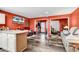 Open living room and kitchen with coral walls and wood-look floors at 500 Fairway Village Dr. # 1-O, Myrtle Beach, SC 29588