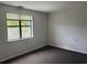 Bright bedroom featuring a large window and neutral carpeting at 5001 Little River Rd. # W-402, Myrtle Beach, SC 29577