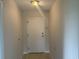 Clean and bright entryway with light flooring and a white door at 5001 Little River Rd. # W-402, Myrtle Beach, SC 29577