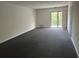 Spacious living room with wall-to-wall carpet and access to a balcony at 5001 Little River Rd. # W-402, Myrtle Beach, SC 29577
