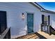 House exterior featuring a teal front door and small deck at 505 Rainbow Dr., Garden City Beach, SC 29576