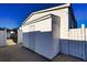 White storage shed with double doors at 505 Rainbow Dr., Garden City Beach, SC 29576