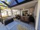 Relaxing screened porch with wicker furniture and ceiling fan at 5126 Wesley Rd., Murrells Inlet, SC 29576