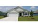 Gray house with white garage door and landscaping at 536 Duvall St., Longs, SC 29568