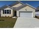 Inviting single-story home featuring a spacious driveway and a well-maintained lawn at 536 Duvall St., Longs, SC 29568