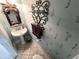 Charming powder room with pedestal sink and decorative wallpaper at 5407 Pheasant Dr., North Myrtle Beach, SC 29582