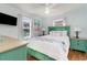 Bedroom with a light teal bed frame, white bedding and ocean-themed decor at 5607 N N Ocean Blvd., North Myrtle Beach, SC 29582