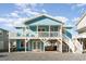 Charming blue beach cottage with wrap-around porch and elevated deck at 5607 N N Ocean Blvd., North Myrtle Beach, SC 29582