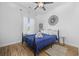 Charming bedroom with a ceiling fan, blue bedding, and wood floors at 5750 Oyster Catcher Dr. # 1124, North Myrtle Beach, SC 29582