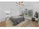 Relaxing bedroom with a large window, hardwood floors, and a ceiling fan at 5750 Oyster Catcher Dr. # 1124, North Myrtle Beach, SC 29582