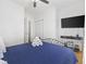 Bright bedroom with a ceiling fan, blue bedding, and built-in closet at 5750 Oyster Catcher Dr. # 1124, North Myrtle Beach, SC 29582