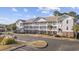 Condo building with parking and surrounding landscape at 5750 Oyster Catcher Dr. # 1124, North Myrtle Beach, SC 29582