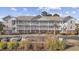 Two-story condo building with ample parking and landscaping at 5750 Oyster Catcher Dr. # 1124, North Myrtle Beach, SC 29582