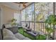 Relaxing screened balcony with wicker furniture and lush greenery at 5750 Oyster Catcher Dr. # 1124, North Myrtle Beach, SC 29582