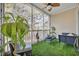 Relaxing screened porch with comfy seating and artificial turf at 5750 Oyster Catcher Dr. # 1124, North Myrtle Beach, SC 29582