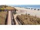 Beachfront boardwalk path leads to sandy beach with umbrellas at 5905 South Kings Hwy. # 908 C, Myrtle Beach, SC 29575