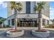 Building entrance with palm trees and signage at 5905 South Kings Hwy. # 908 C, Myrtle Beach, SC 29575