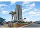 Tall building exterior with palm trees and parking at 5905 South Kings Hwy. # 908 C, Myrtle Beach, SC 29575