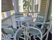 Screened balcony with small table and chairs, overlooking pool at 601 Hillside Ave. N # 1623, North Myrtle Beach, SC 29582