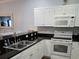 Kitchen with white cabinets, granite countertops, and stainless steel appliances at 601 Hillside Ave. N # 1623, North Myrtle Beach, SC 29582